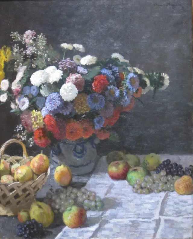 A painted still life of flowers in a vase, with fruit, a basket, and a pale tablecloth.